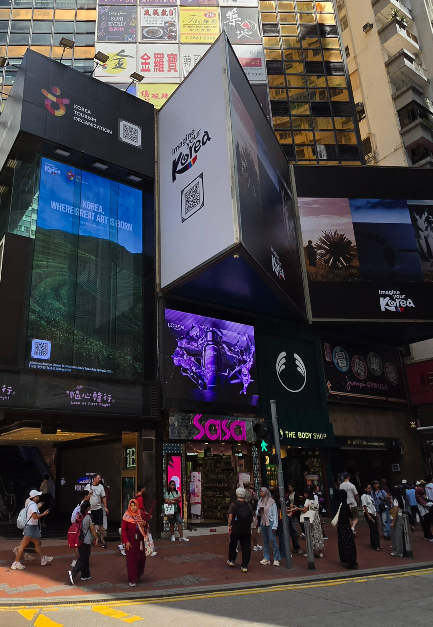 Vertical LED screen on a commercial building corner in Singapore